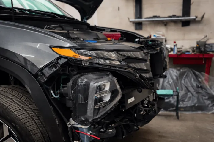 SUV front end torn down for collision repair in the Scenic 61 shop